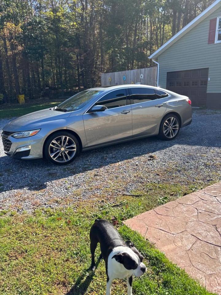 Silver Chevrolet Malibu with window tint at the customer's home