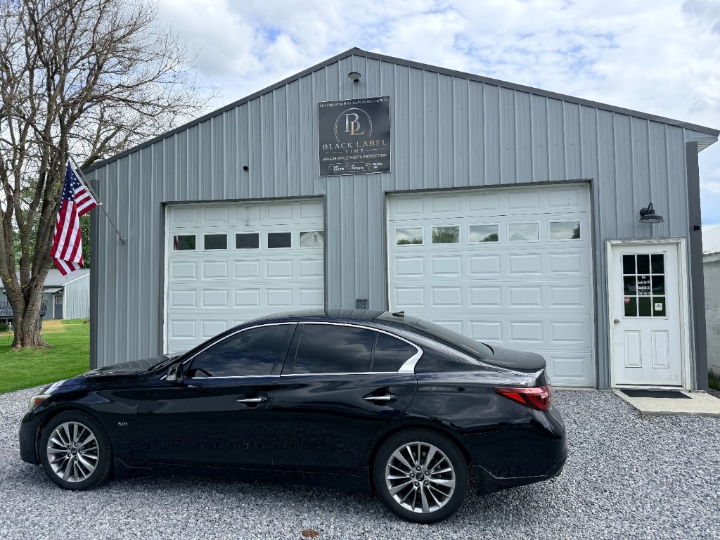 Sedan with fresh auto window tint outside the Black Label Tint shop in Glen Hope